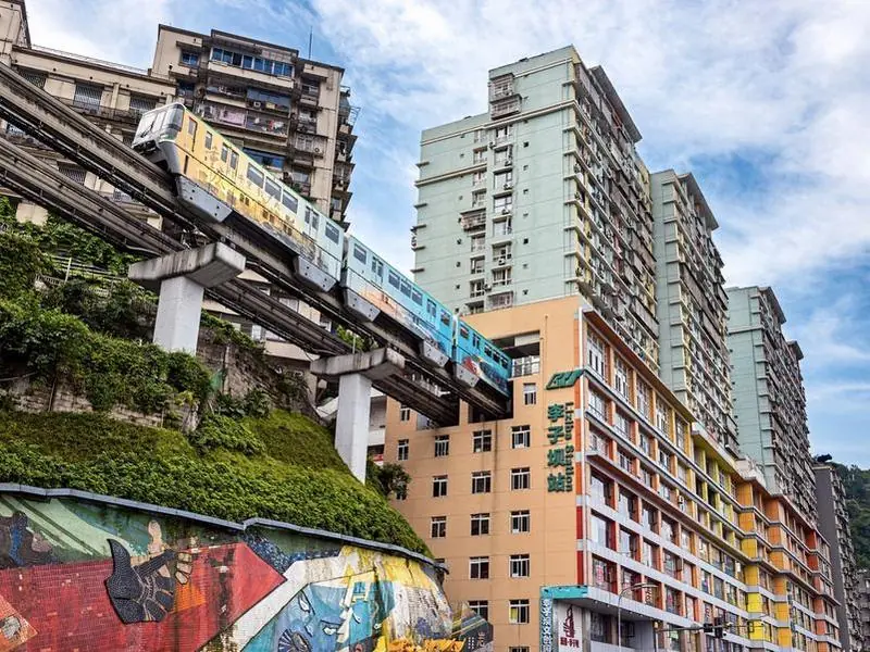 Chongqing's Liziba monorail train passing through the residential building it runs through