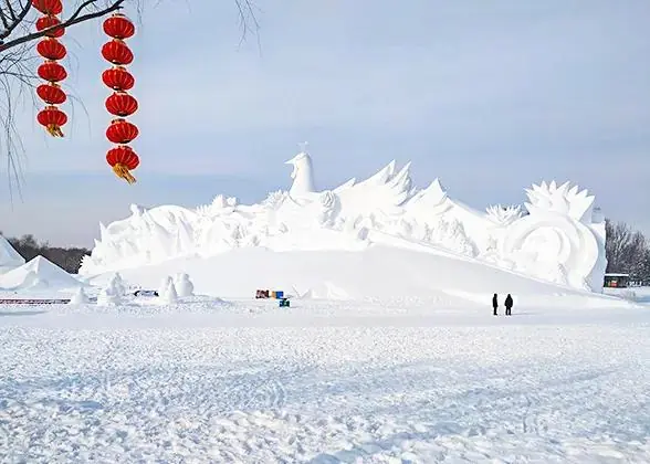 A monumental carved-snow sculpture at the Sun Island snow expo in Harbin, visitors walking on the snowfield below