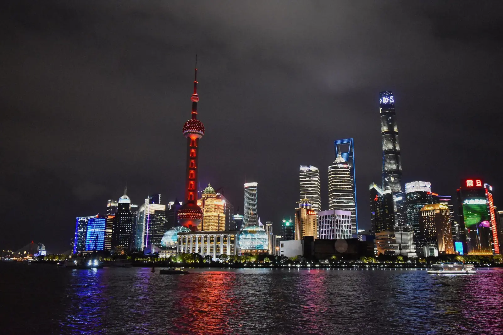 Shanghai skyline at night with the Oriental Pearl Tower lit up across the Huangpu River